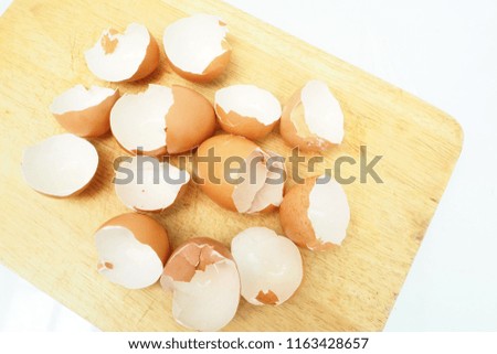 Eggs shell isolated on a chopping wood
