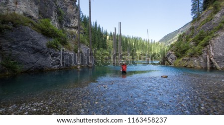 the photographer is standing on the river