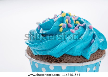 Tasty colorful cupcake isolated on white background, close up.