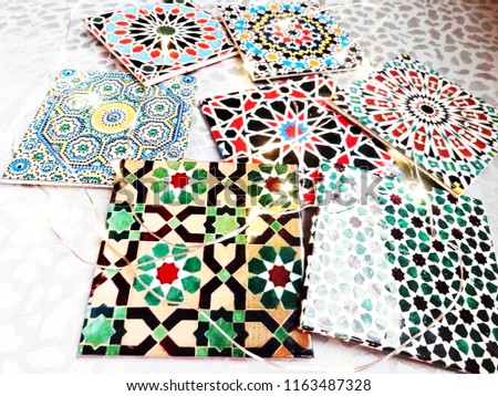 A selection of colorful Moroccan tiles, displaying traditional geometric patterns.