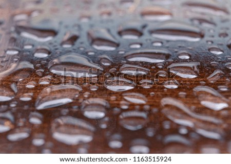 Drops of rain on the table.