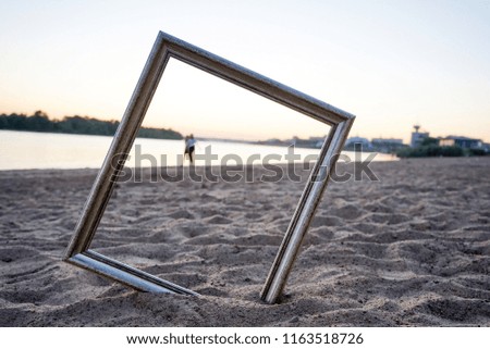 the picture frame is stuck in the sand
