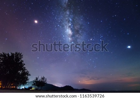 Milky Way galaxy and starry night sky at Kelambu Beach Kudat, Malaysia. soft focus and noise due to long expose and high ISO.