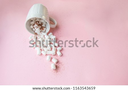 marshmallows crumbled from white circles on a pink background