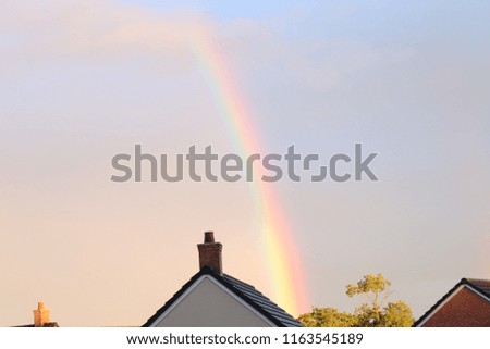 Rainbow and rooftops ,dreams come true. Pot of gold