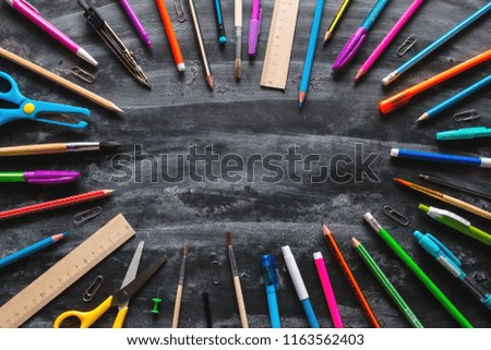 circle of school supplies on a blackboard with space for text