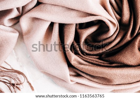 Autumn background. Beautiful elegant brown scarf. Flat lay, top view