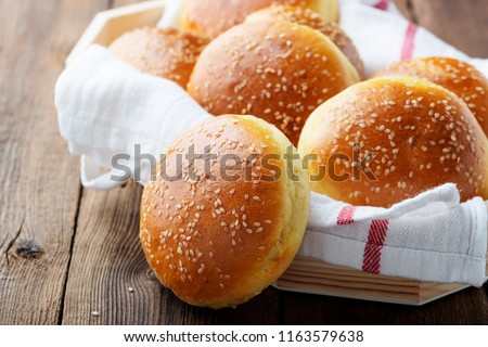Fresh homemade burger buns with sesame. Royalty-Free Stock Photo #1163579638