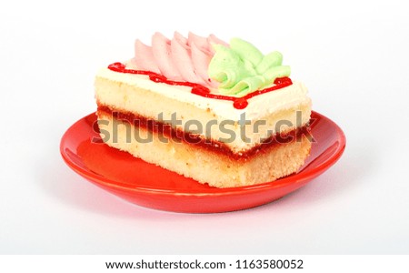 Tart, cookie pie, cake with multi-colored cream and jelly on a red plate, isolated on a white background with clipping path.