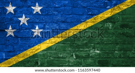 Flag of Solomon Island over an old brick wall background, surface.