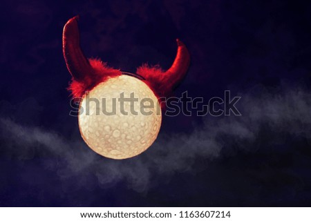 Halloween background with moon wearing devil horns and mist