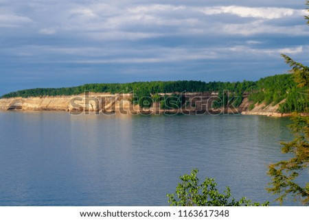 The sun illuminates the Cliffs at Pictured Rocks National Park