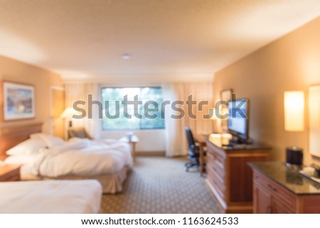Motion blurred typical double room with windows, flat-screen TVs in American hotel