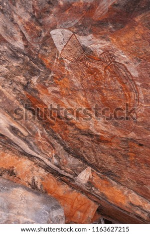 This is a mural painting of Aborigines drawn on a rock.