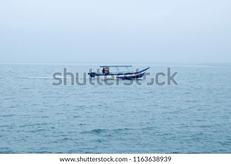 A picture of passenger boat hovering at the sea looking for tourist in Batu Ferringhi,Penang.