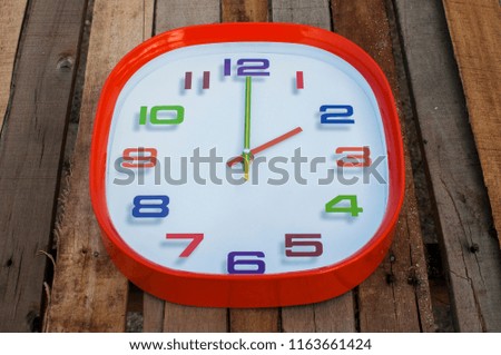 2 o'clock over wooden background