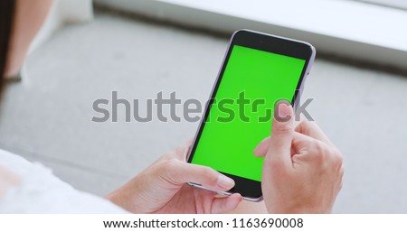 Woman use of smart phone with green screen, chroma key