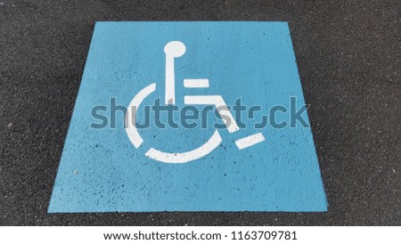 Disabled parking space sign on road