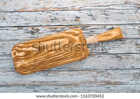 Kitchen old wooden board. On a white wooden background. Free space for text. Top view.