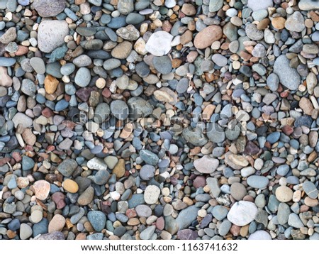 Seamless repeating image of pebbles on a beach.  Genuinely repeatable without editing.