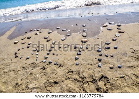 Pebbles in a sandy beach forming 2019 Crete