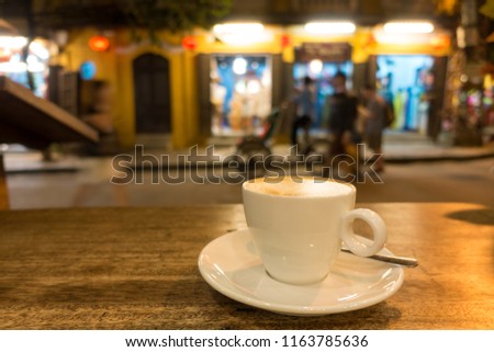 A cup of capuchino coffee in night. Royalty high quality free stock image of a cup of capuchino coffee in a coffee shop. Drink coffee is the habit of many people 