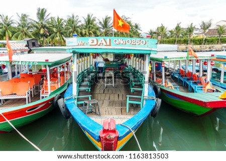 Three colorful boats on Thu Bon River in the tourist hot spot of Hoi An.