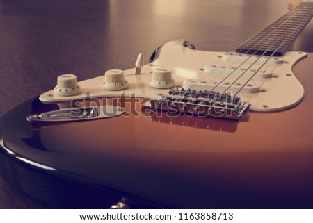 Electric guitar stratocaster sunburst closeup, macro abstract Royalty-Free Stock Photo #1163858713