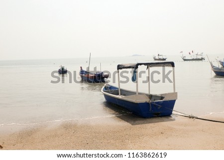 A picture of a boat dock at the seashore during low tide at Tanjung Bungah, Penang.