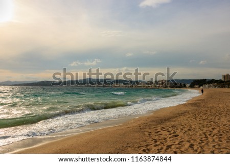 Big waves in a sunny day in Palamos, Costa Brava, Spain.
Man walking on the beach.