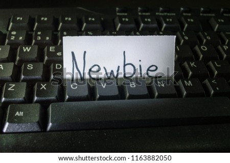 word newbie written on a piece of white paper and placed on black computer keyboard. Concept technology tech words, digital vocabulary, terms used on the internet