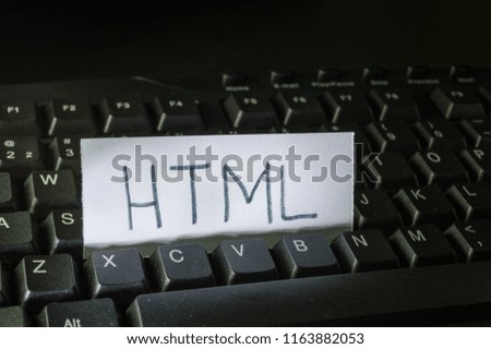 word html written on a piece of white paper and placed on black computer keyboard. Concept technology tech words, digital vocabulary, terms used on the internet