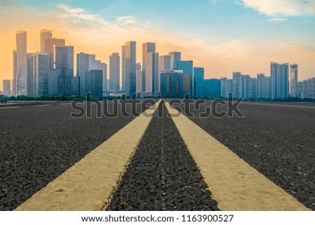 Urban road asphalt pavement and skyline of Hangzhou architectura