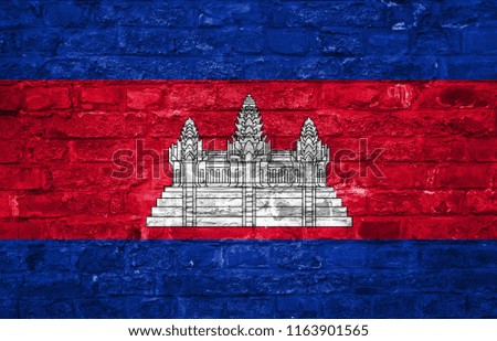 Flag of Cambodia over an old brick wall background, surface.
