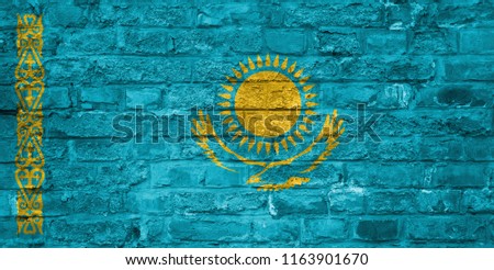 Flag of Kazakhstan over an old brick wall background, surface.