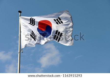 Bonn, North Rhine-Westphalia / Germany - May 14, 2018: The flag of South Korea waving against blue sky in front of the South Korean Embassy in Bonn, Germany