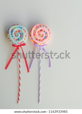 Blue and pink ornamental lollypops isolated on white background with copy text space on the right side