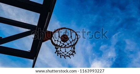 basketball hoop and ball on the sky background