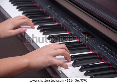 Closeup woman's hand playing piano. Favorite classical music.