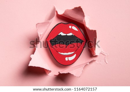 Red chubby cut paper origami lips on pink background. Royalty-Free Stock Photo #1164072157