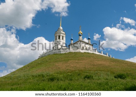 Church standing on a high and green hill