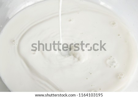 Pouring milk splash on the white background
