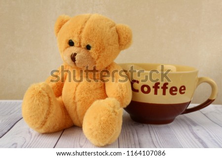 Little plush bear with cup of coffee. Good morning. Have a nice day!