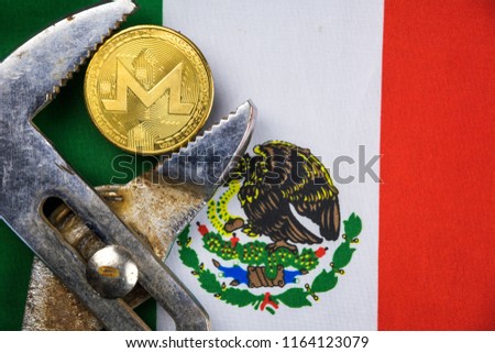 Monero coin being squeezed in vice on Mexico flag background; concept of cryptocurrency monero (xmr) under pressure. Prohibition of cryptocurrencies, regulations, restrictions or security