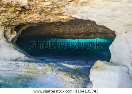 Lon exposure photo of emerald turquoise blue water sea cave in Cyprus, Paphos