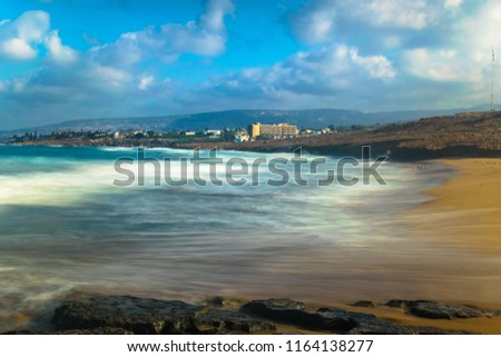 Long exposure photograph of sea shore in Cyprus, Paphos at Sandy beach, known as Surfer beach. This is part of a photo set with similar images showing slightly different wave motion