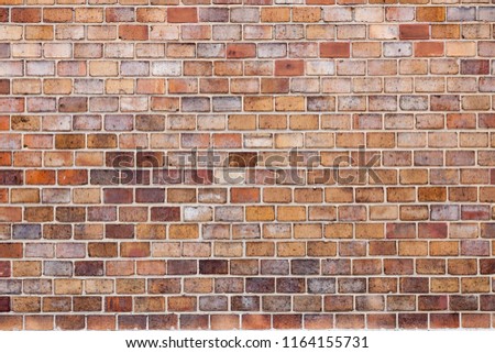 Fragment of old destroyed red and yellow brick wall background. Cracked Tile stone texture. Crumbling dirty Vintage Surface. Copy Space for text, design ideas.