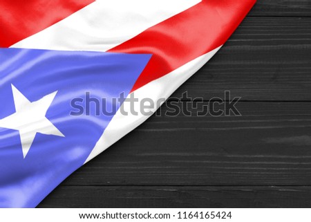 Puerto Rico flag and space for text on a dark wooden background