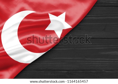 Flag of the Ottoman Empire and place for text on a dark wooden background