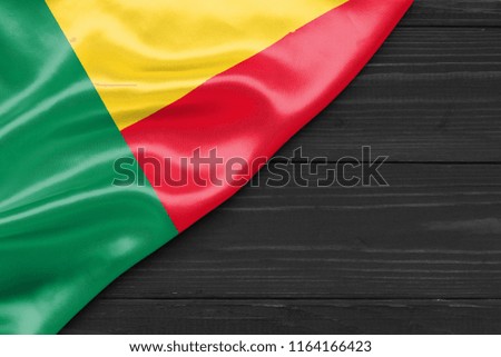 Flag of Benin and place for text on a dark wooden background